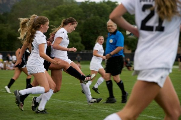 Women's soccer team passing ball