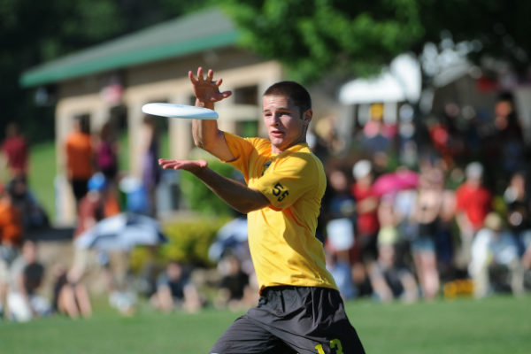Men's ultimate player catching frisbee