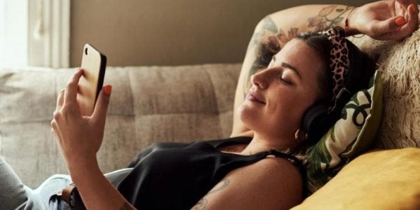 girl on couch looking at phone
