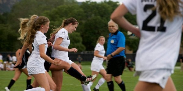 Women's soccer team passing ball