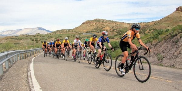 Cycling team biking uphill