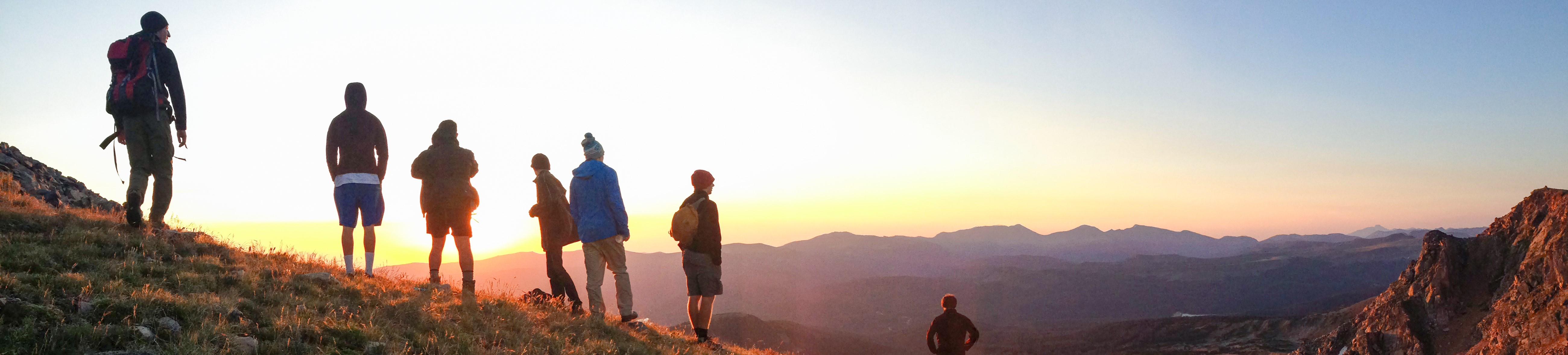 students looking out onto the sunset