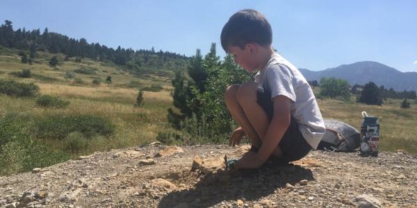 boy digging in rocks
