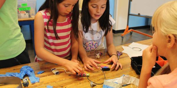 2 girls playing with makey makeys