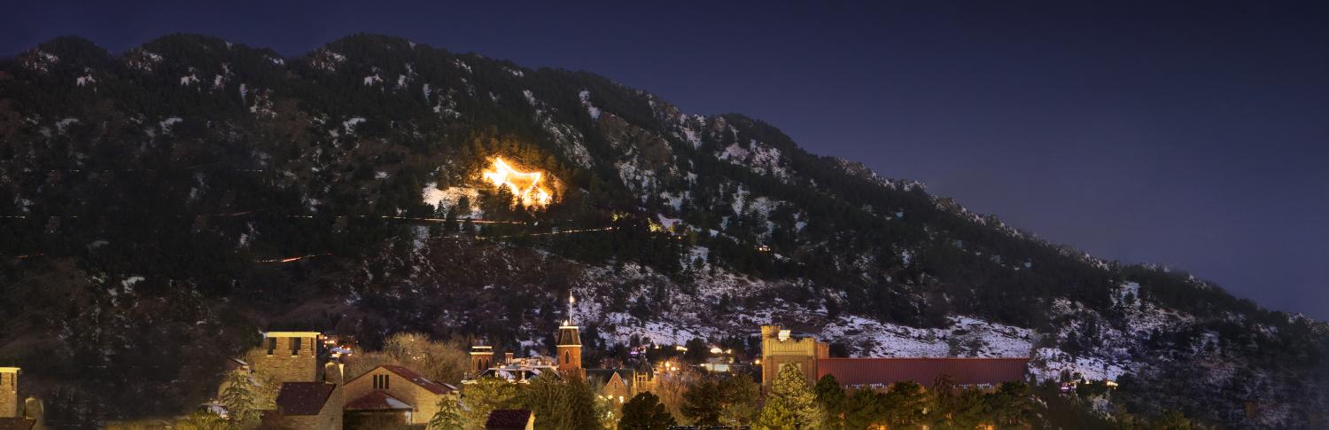 Campus with the Boulder Star in the background lit up over Flagstaff Mountain
