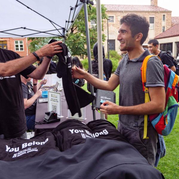 A booth hands out shirts at the CUnity Fest