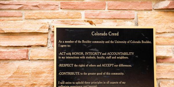 Colorado Creed plaque hanging on brick wall
