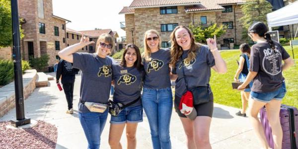 Four women posing in CU Boulder shirts at Fall Welcome