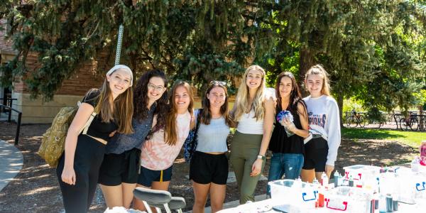 Students posing with tie-dye supplies during a transfer student event