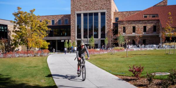 Person riding their bike through campus