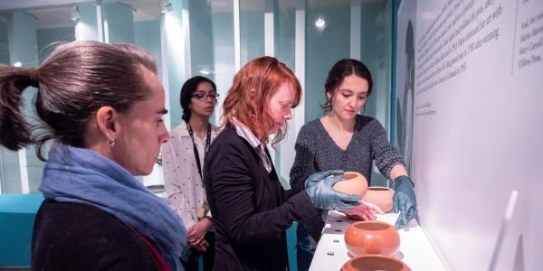 People looking at pottery