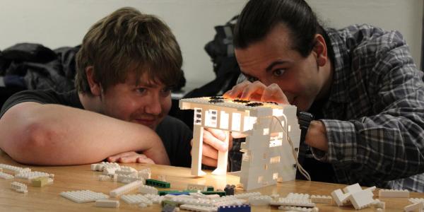 Two students work on a Lego lighting project during their architectural lighting design class