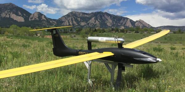 Unmanned flying vehicle parked in a field near Boulder