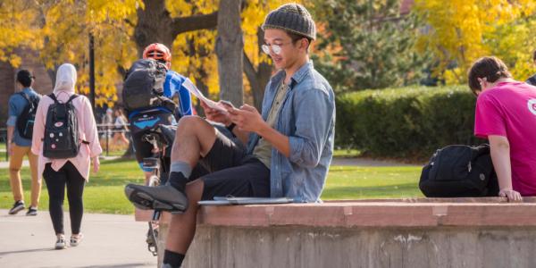 Student sitting outside on a bench