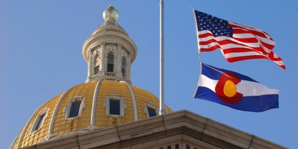 U.S. and Colorado state flags at Colorado State Capitol Building
