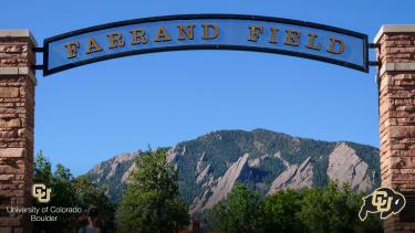 Sign over Farrand Field with Flatirons in the back