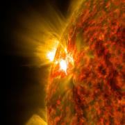 An active region on the sun emits a solar flare