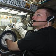 NASA astronaut Terry Virts manipulating a BioServe experiment on ISS. 