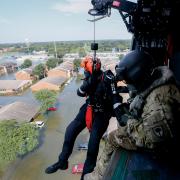 Rescuer lowered from helicopter over Houston flooding