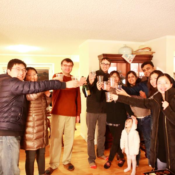 cheers at a holiday party in winter 2016
