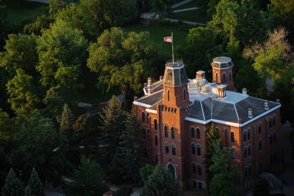 Aerial shot of Old Main Building surrounded by trees