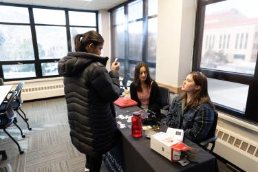 A student meets with two other students at a Wellness Wednesday event