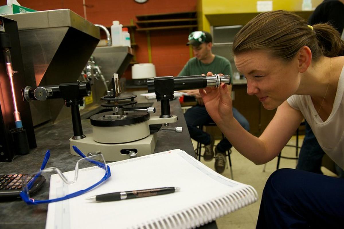 Student looking into a microscope