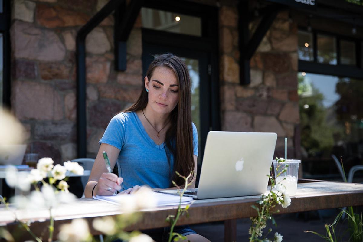 Student writing in notepad