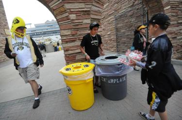 Alex Mitoma, a CU-Boulder environmental engineering student, center, volunteers to show football fans which bin to put their waste away during the CU vs. Hawaii football game at Folsom Field on Sept. 18, 2010.