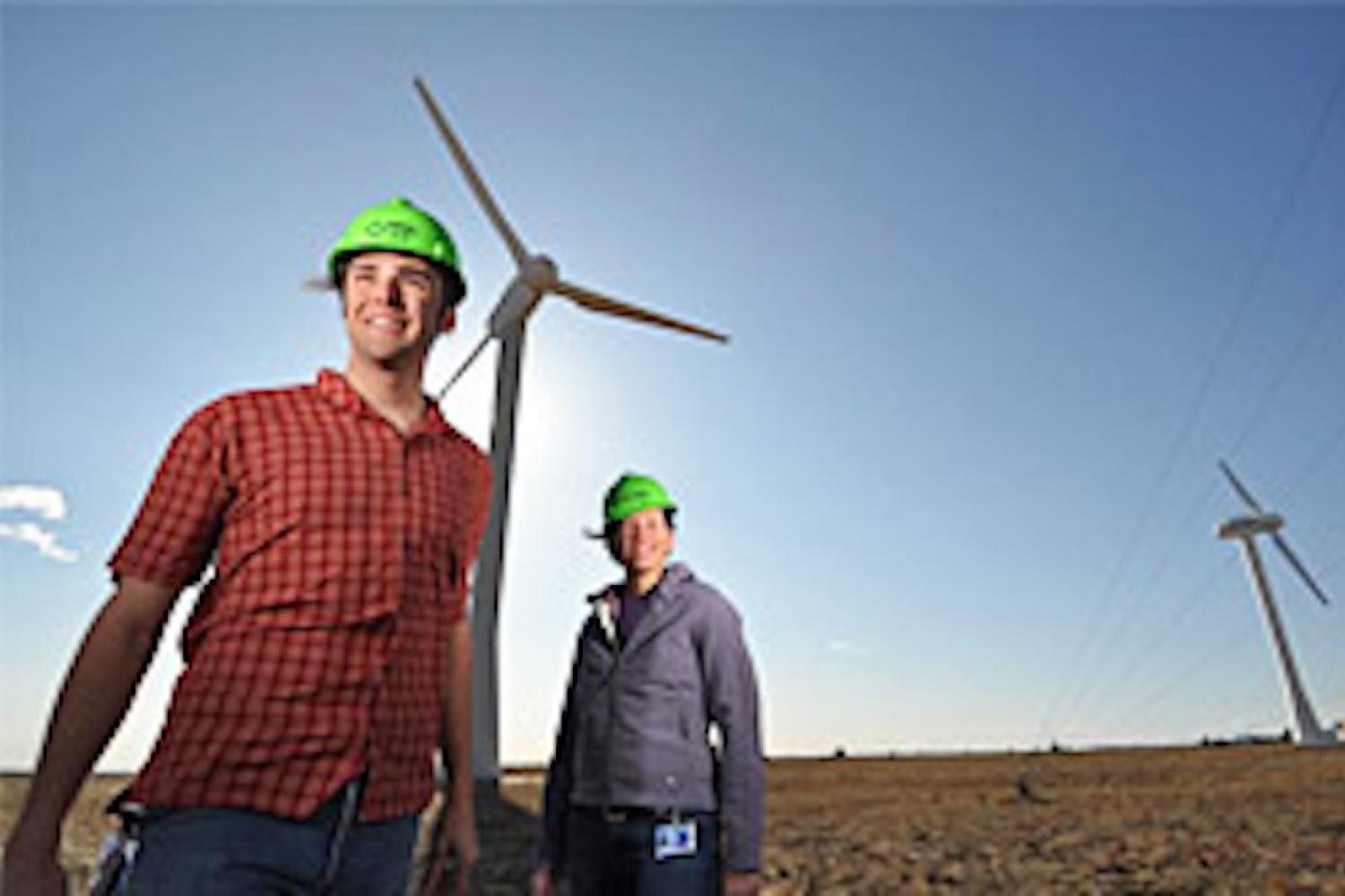 Workers in hard hats under Wind turbine