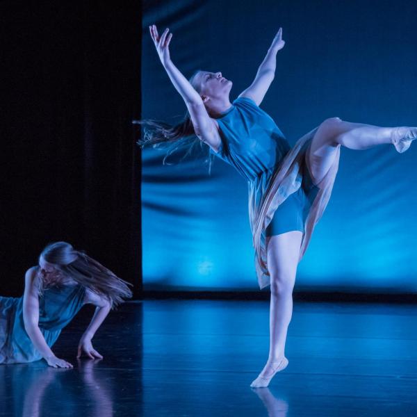 Two female students performing a dance
