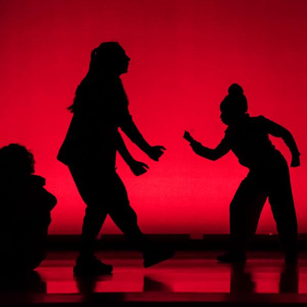 Dance performance in a red lit theatre