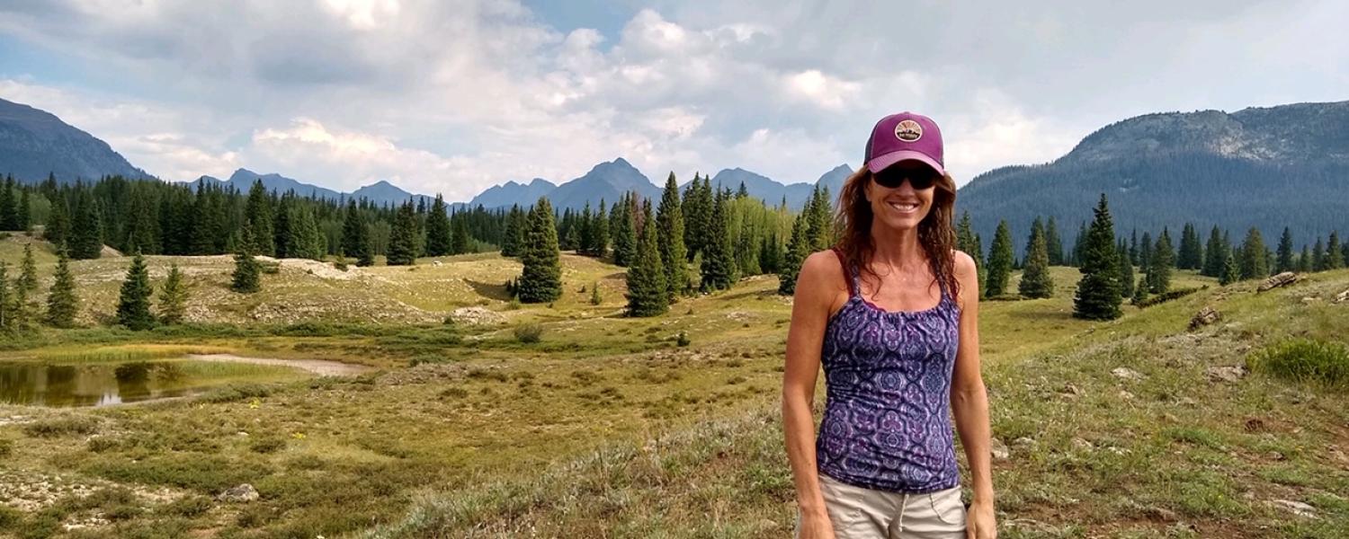 Lisa Marshall standing in a mountain field.