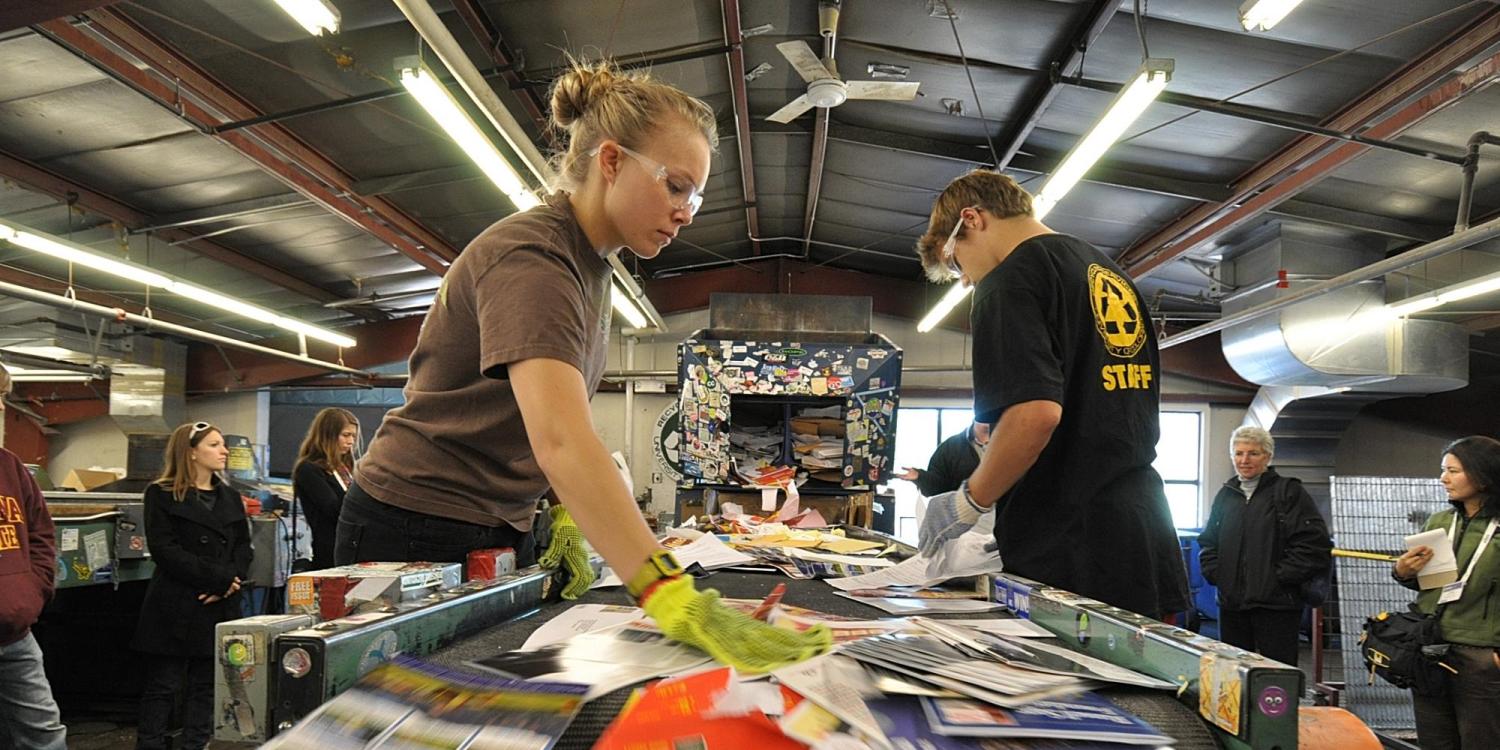 Students work at Recycling Center during campus sustainability tour