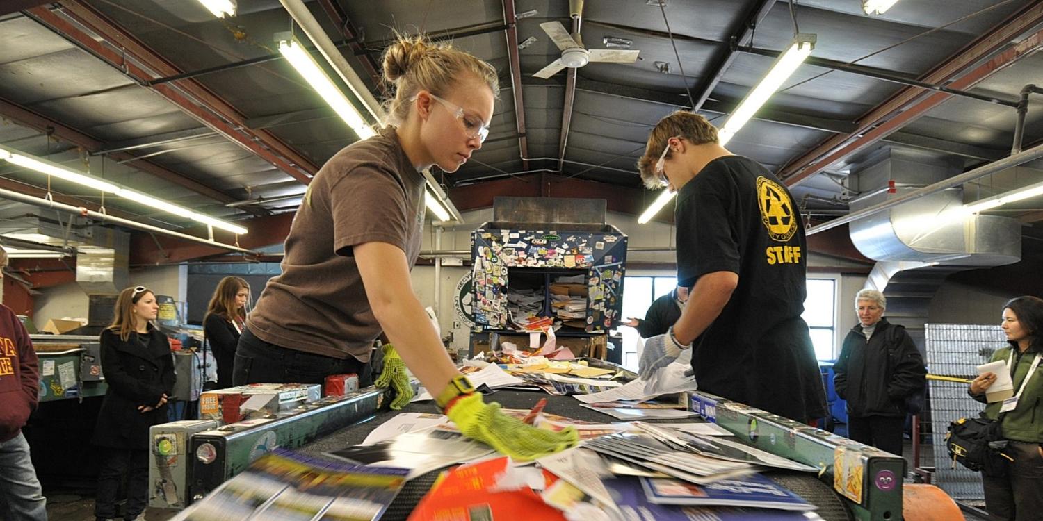 Students sort through recycled material in the Recycling Center at CU Boulder