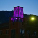 On March 5, the Roser ATLAS building shines magenta––part of the state of Colorado's COVID-19 anniversary remembrance. (Photo by Glenn Asakawa/CU Boulder)
