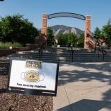 A Protect Our Herd–face covering required sign at the entrance of Farrand Field