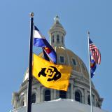 state capitol building with U.S., state and CU flags 