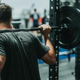 A person lifting a barbell (Photo by Andrew "Donovan" Valdivia/Unsplash)