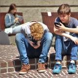 Two boys on their smartphones