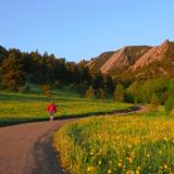 Person hiking at sunrise in Chautauqua Park in Boulder, Colorado