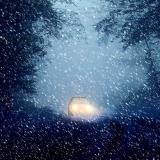 Car driving through snow storm