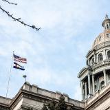 Denver capitol building with state and national flag flying