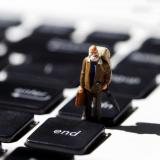 Image of a old man figurine on a keyboard