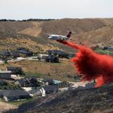 An airtanker drops retardant to help stop the spread of the 2015 Eyrie Fire in the foothills of Boise, Idaho, which was ignited by sparks from construction equipment.
