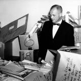 John Glenn looking through piles of mail