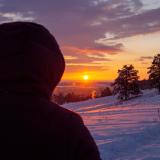 Person watches sun rise over the Flatirons