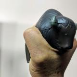 Person squeezes a Buff-shaped stress ball