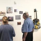 People visiting a Museum of Boulder exhibit on music