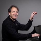 David Korevaar conducts from the piano